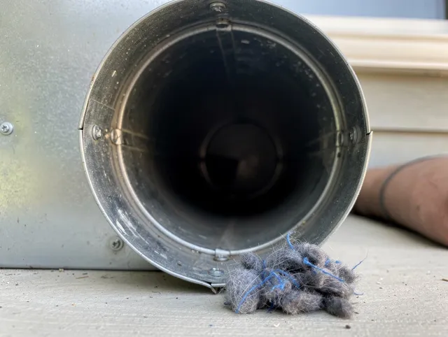 Jacksonville Dryer Vent Cleaning technician using specialized equipment to clear severe dryer vent blockage in Jacksonville